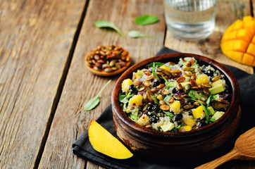 Mango black bean arugula pumpkin seed quinoa salad