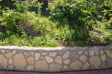 Stone wall with greenery. Texture of nature. Background for text, banner, label.