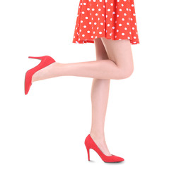 Young woman wearing dress and high heels on white background