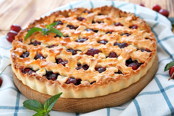 Tasty cherry pie on table
