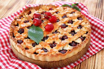 Tasty cherry pie on table