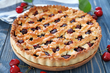 Tasty cherry pie on wooden table