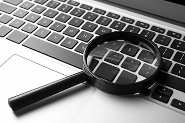 Magnifying glass on laptop. Internet search concept