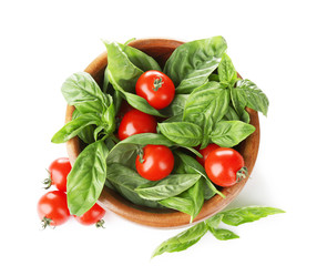 Cherry tomatoes and green fresh organic basil isolated on white