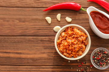 Meat sauce in ceramic bowl on kitchen table