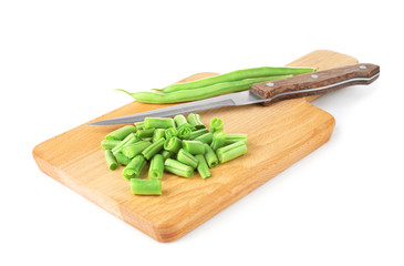 Wooden board with fresh green beans on white background