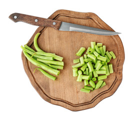 Wooden board with fresh green beans on white background