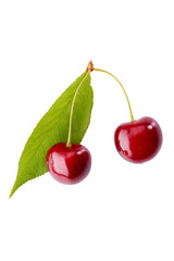 Two ripe cherries with leaf on white