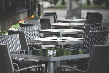 Multiple black restaurant tables and chairs outside the cafe, Kaunas, Lithuania