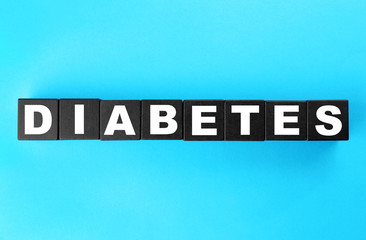 Word Diabetes made of dark cubes on color background