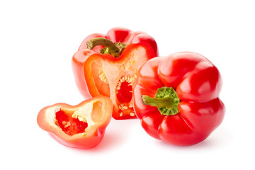 Whole and sliced bell peppers over white