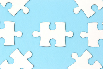 Fototapeta premium Leadership business concept - jigsaw on blue background. Minimal style. Flat lay.