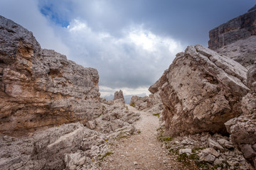 Fototapeta premium Path in the middle of giant boulders, Dolomites, Cortina d'Ampezzo, Italy