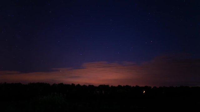 Star Time Lapse. Night cloudy sky with the Moon