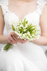 wedding white bouquet in bride's hands white background