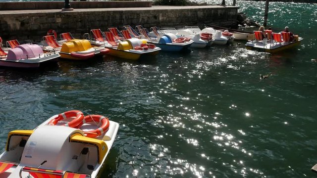 Tourists leave the pier on a catamaran on Lake Garda on a summer day
