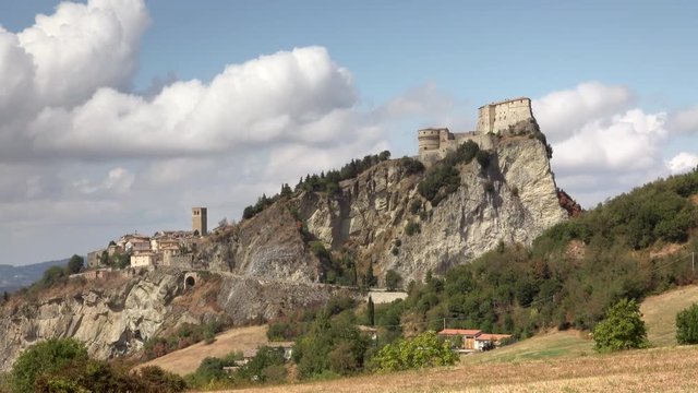 timelapse shot of view of medieval village on rock spur in Italy
