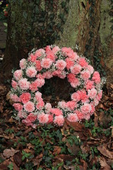 Pink Sympathy wreath near a tree