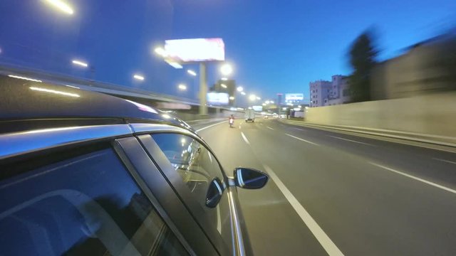 Driving at high speed through the night city highway. Pov blurred timelapse with view from outside of the cabin.