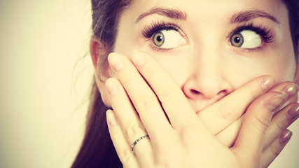 Woman covering her mouth with hand