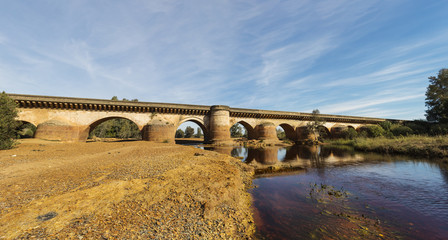 Roman Bridge with reflections in Tinto River, Niebla
