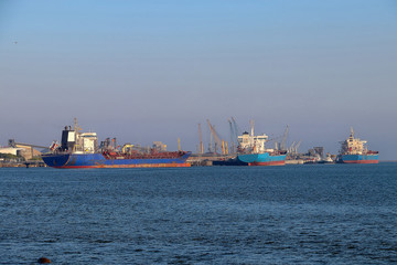 Cargo ship loading. Logistics and transportation with working crane bridge in harbor, logistic import export background and transport industry, Freight Transportation, Shipping, Nautical Vessel