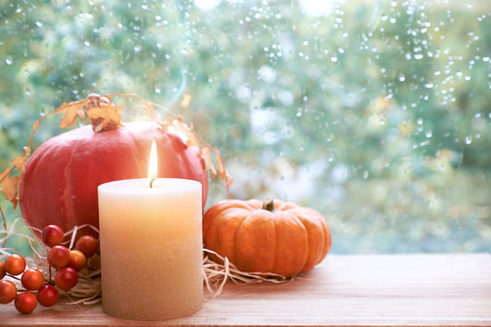 Burning Candle, Pumpkin And Fall Decorations On A Windowboard, Space