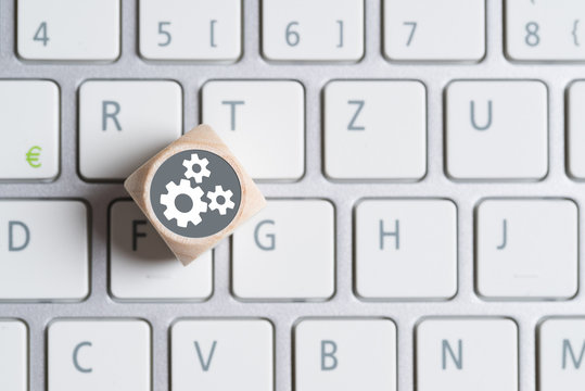 W&uuml;rfel auf Tastatur mit Getriebesymbolen