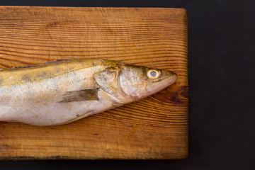 Fish on wooden cut board