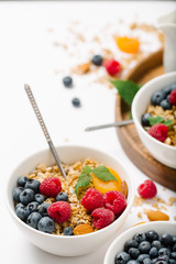 Homemade granola and healthy breakfast ingredients - milk, dried fruit and berries