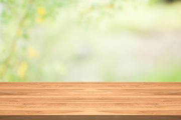 Wood table top on nature green blurred background,for montage your products