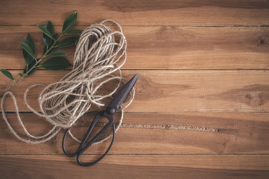 Old scissors and ropes on wooden floor