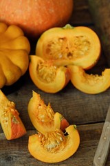 Delicious fresh orange pumpkin on wooden table 