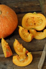 Delicious fresh orange pumpkin on wooden table 