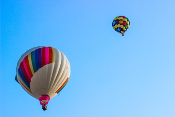 Two Multi Colored Hot Air Balloons In Early Morning