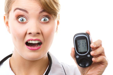 Shocked woman holding glucometer with bad result of measurement sugar level, concept of diabetes