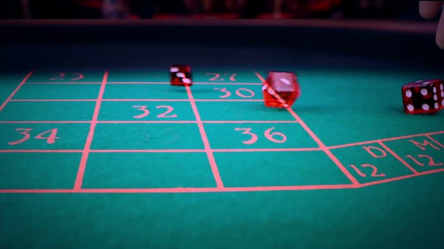 three red dice rolling on green game gambling table, shooting with slow motion, concept of sport recreation leisure game in the casino