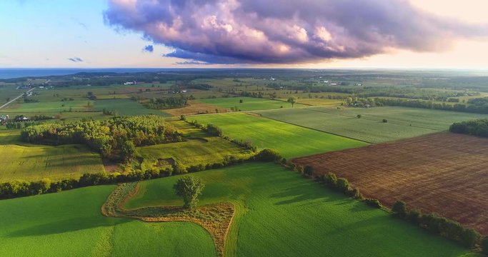 Scenic Rural Landscape with amazing early morning lighting and heavy clouds, aerial view.