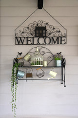 Vintage welcome sign decorate on wall and small decoration behind welcome sign bending from steel.
