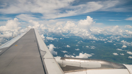 View of airplane window with sky background.