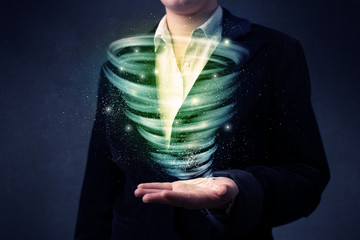 Businessman holding green tornado