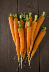 fresh carrots on wooden surface
