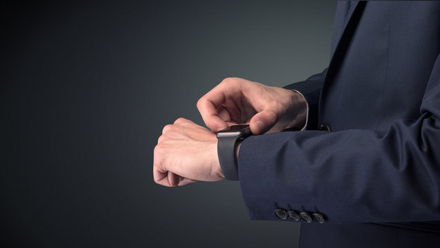 Man in suit wearing smartwatch.