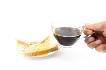Man hand is holding  a black coffee cup with the bited of slide bread on the dish