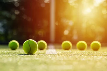 Foto op Canvas soft focus of tennis ball on tennis grass court with sunlight © kireewongfoto