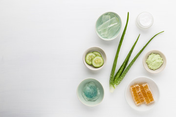 Homemade herbal dermatology cosmetic hygienic cream for beauty and skincare product. honey, cucumber, aloe vera, salt, mint on white background.
