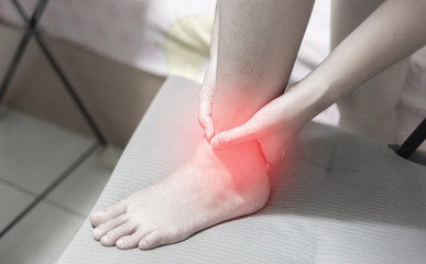 sport injury concept, woman suffering from an ankle injury while exercising and running.