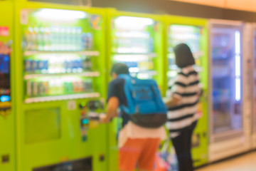 Abstract blur of people paying for the drinks from the vending machine