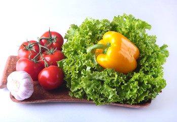 Fresh assorted vegetables bell pepper, tomato, garlic with leaf lettuce. Isolated on white background. Selective focus.