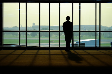 Fototapeta na wymiar Silhouette of people in the airport / Silhouette of people in the airport at morning time, Thailand